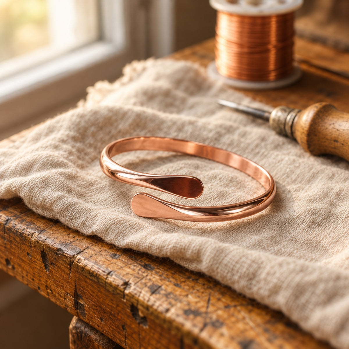 Veyra Drop Copper Bracelet on linen